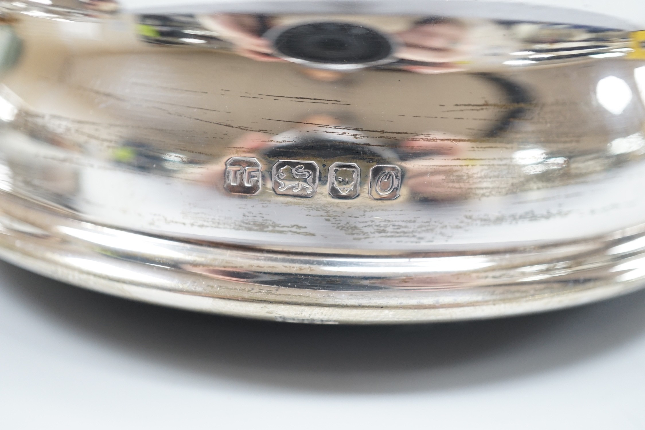 A pair of modern silver wine coasters, diameter 12.4cm and a single silver mounted wine coaster.